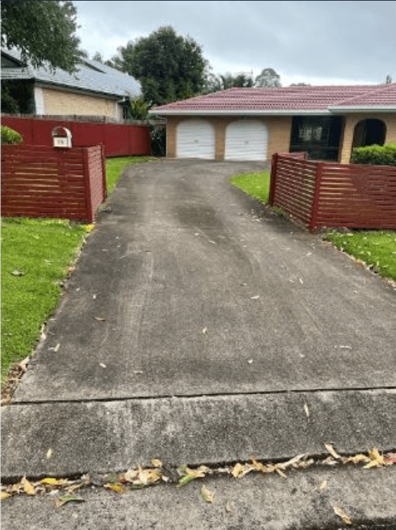 Weathered residential concrete driveway before pressure washing